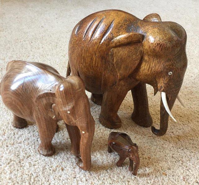 Preview of the first image of Set of three wooden carved elephants.