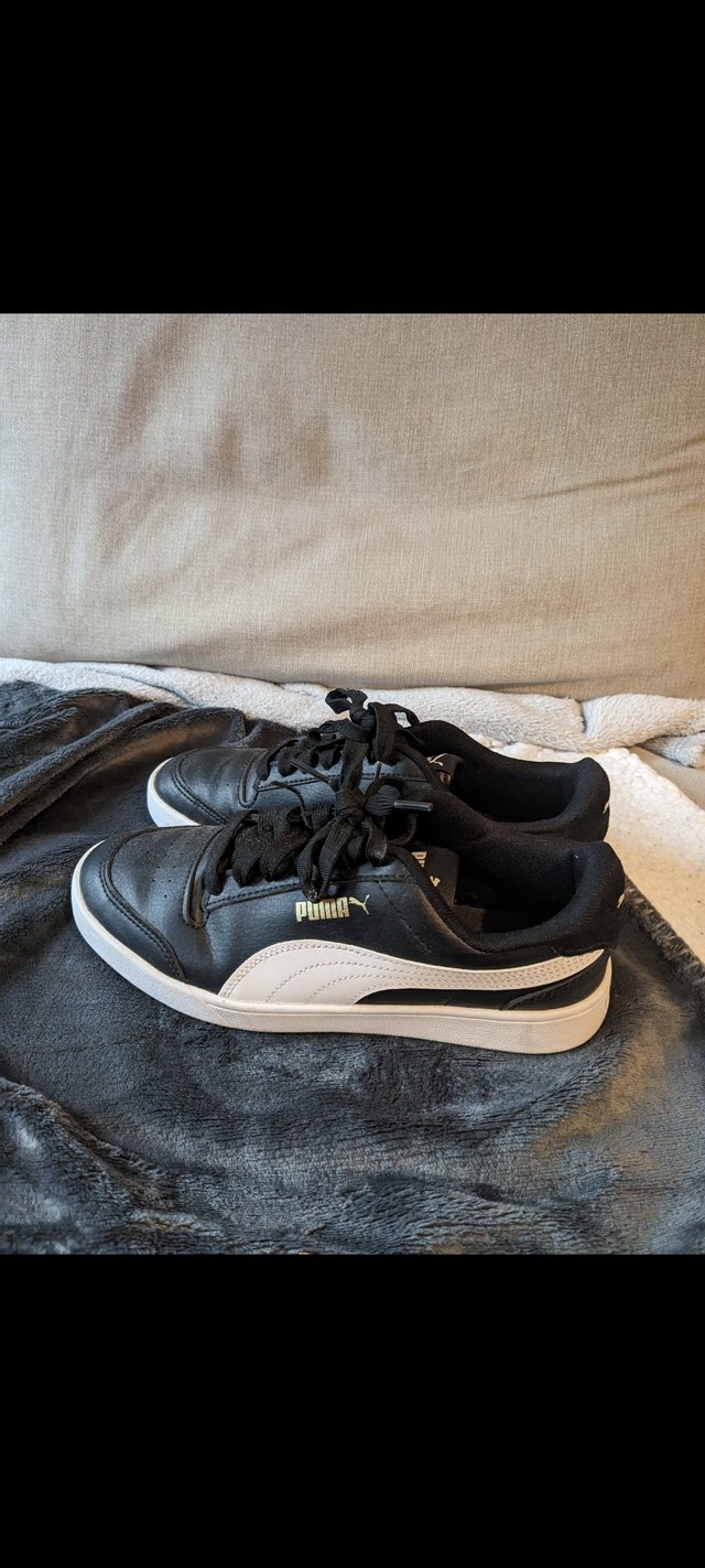 Preview of the first image of Puma black trainers size 5.