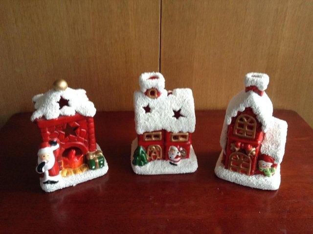 Preview of the first image of THREE CERAMIC CHRISTMAS CANDLE/TEA LIGHT HOLDERS.
