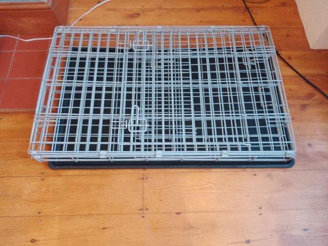 Preview of the first image of Folding metal dog cage with base.
