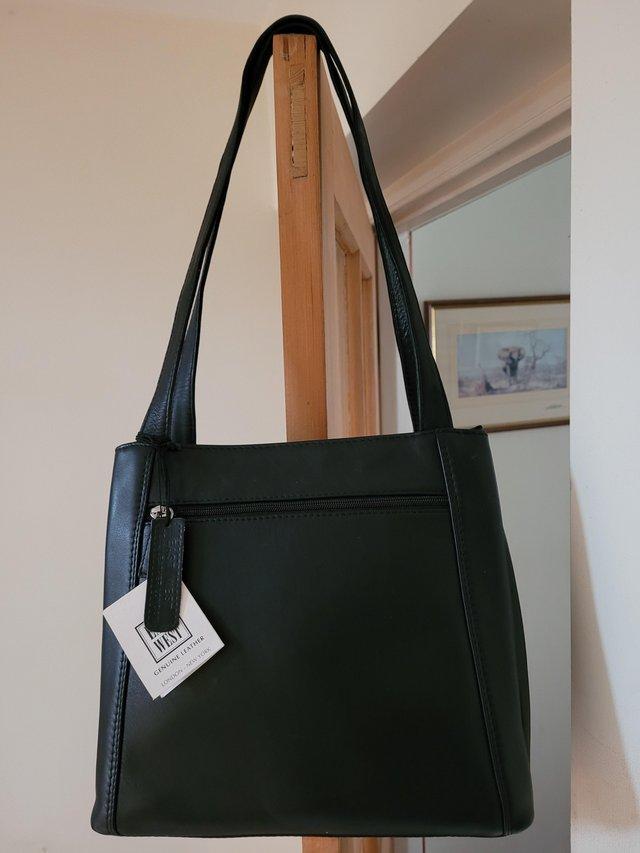 Preview of the first image of New black leather shoulder bag with 4 zipped sections.