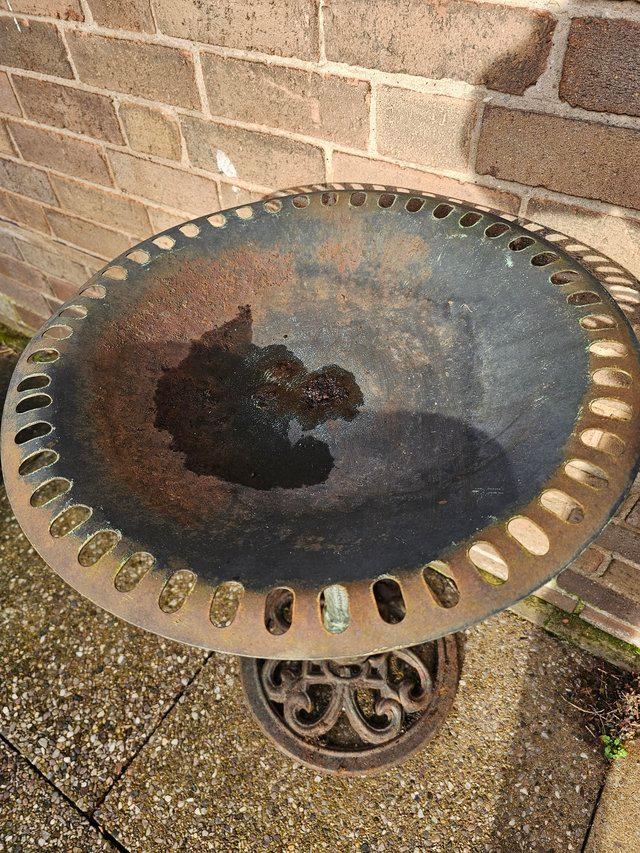 Preview of the first image of Heavy iron/metal bird bath with nice worn patina.
