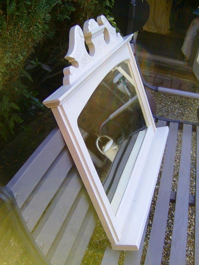 Preview of the first image of Vintage wooden mirror with ornate top.