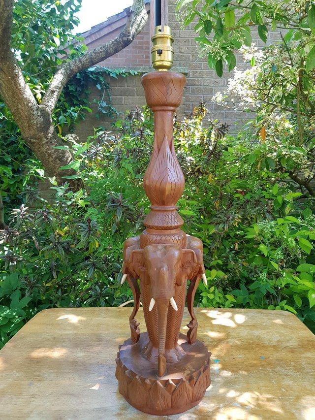 Preview of the first image of Vintage solid teak carved trio of elephants lamp base.