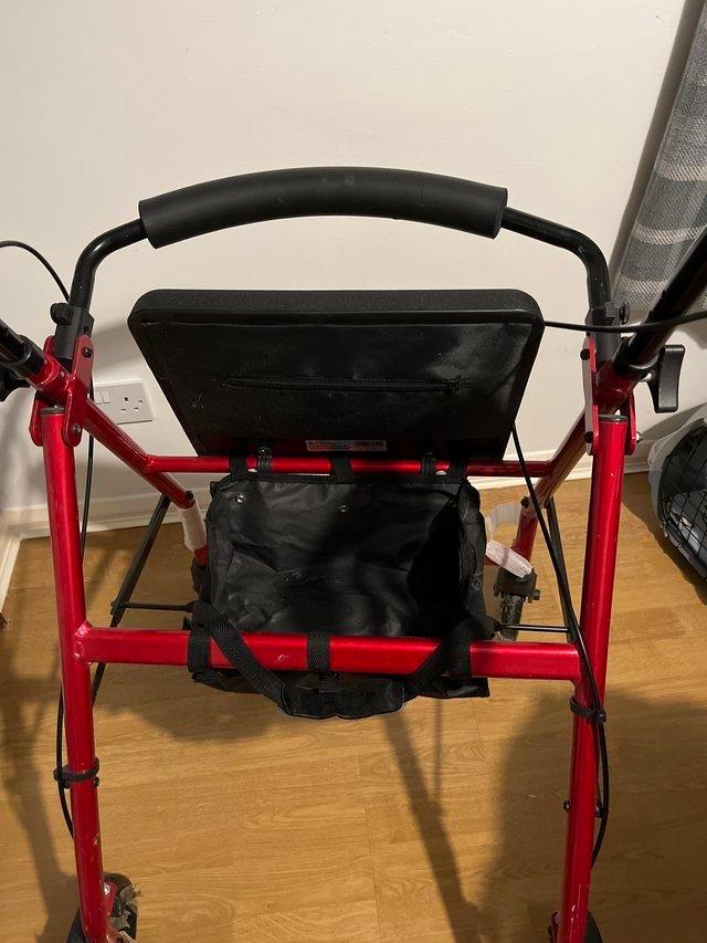 Preview of the first image of Four Wheel Walker Colour Red With Seat.