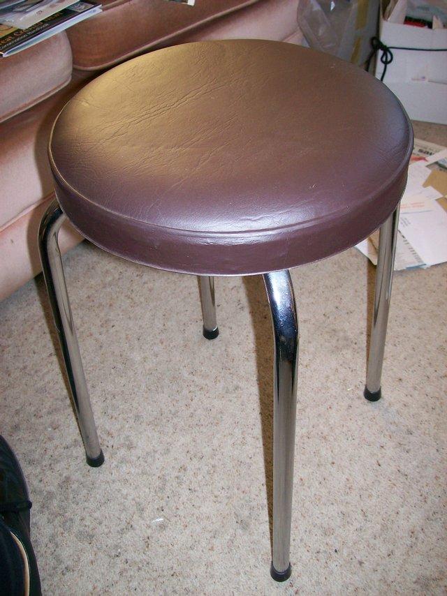 Preview of the first image of Chrome-legged stool with whitish padded seat pad..