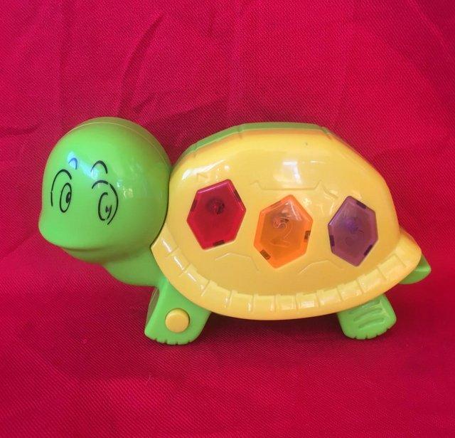 Preview of the first image of Musical flashing light tortoise toy. Plays 3 tunes. Can post.