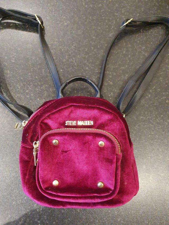Preview of the first image of Steve Madden mini red velvour backpack.