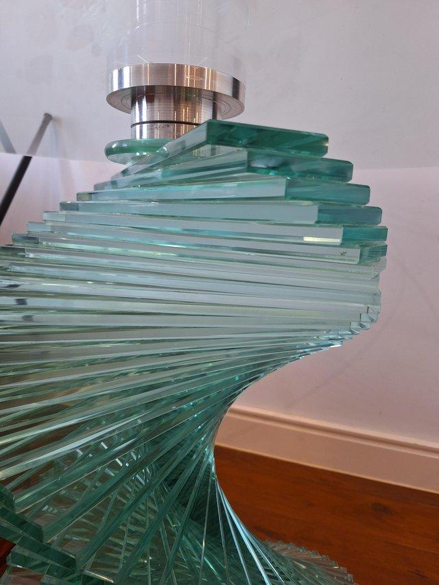 Preview of the first image of Stunning Round Glass Dining Table with Spiral Base.