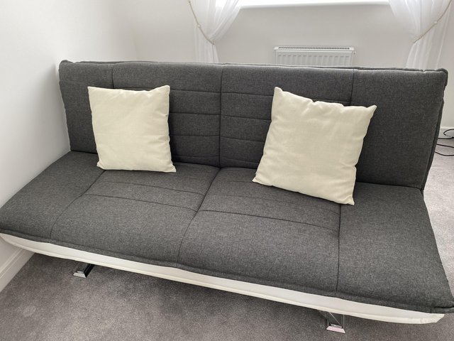 Preview of the first image of Charcoal grey material sofabed with chrome legs.