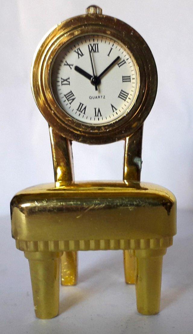Preview of the first image of MINIATURE NOVELTY CLOCK - A PADDED CHAIR.