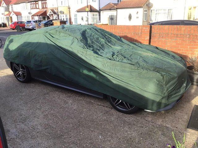 Preview of the first image of Car cover as Good as new heavy duty on the side it says ROVE.