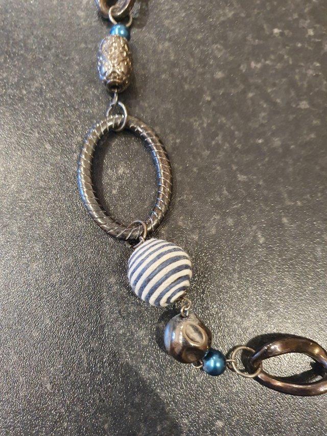 Preview of the first image of Dark silver, blue & striped necklace.