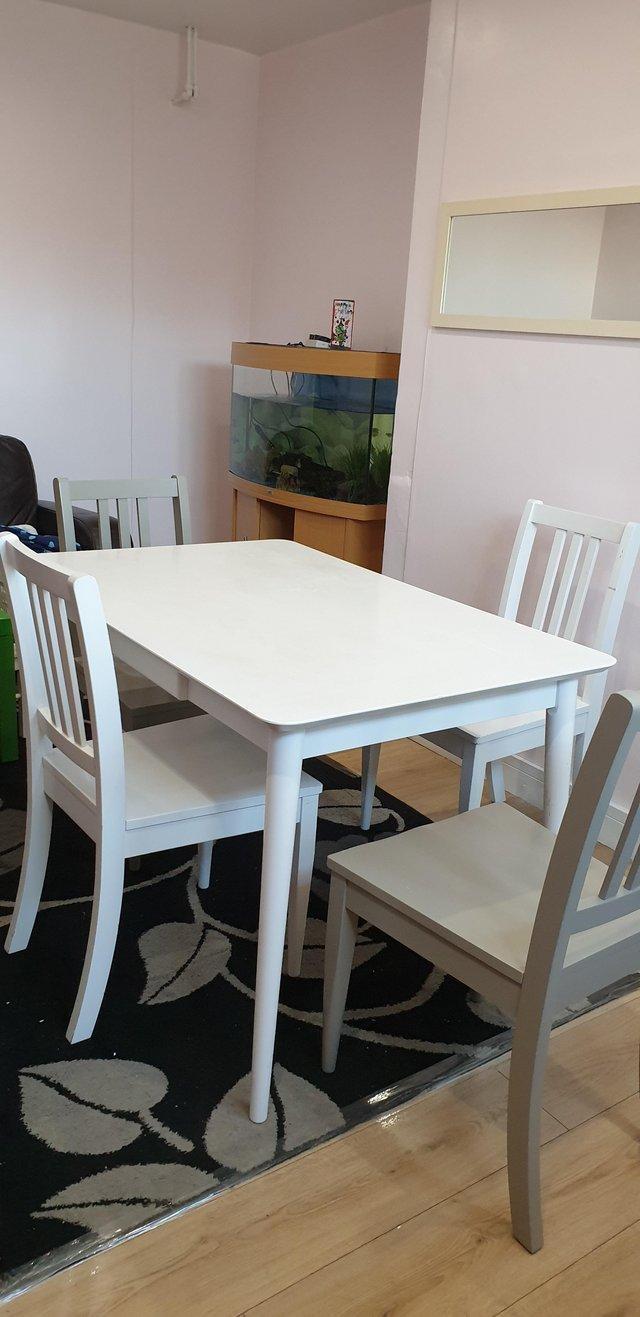 Preview of the first image of Compact modern dining table and 4 chairs.