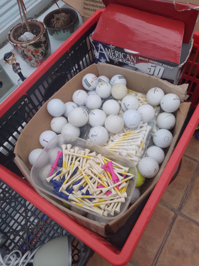 Preview of the first image of Various golf balls with boxes of tees.
