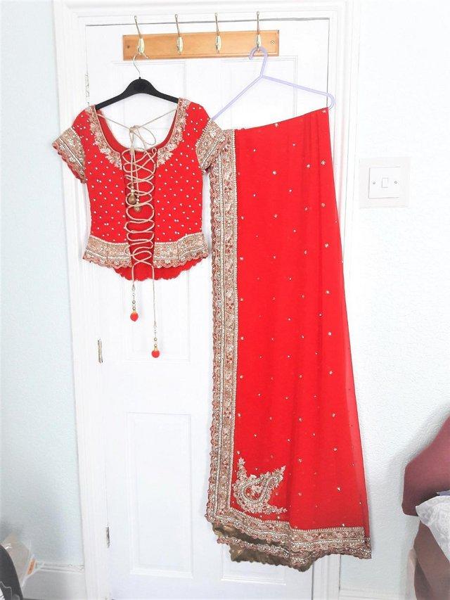 Preview of the first image of Bright red, gold and diamante wedding lengha.