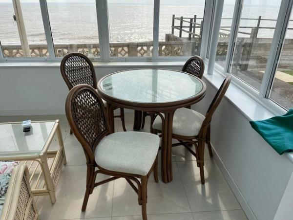 Image 1 of Cane and glass table and four chairs