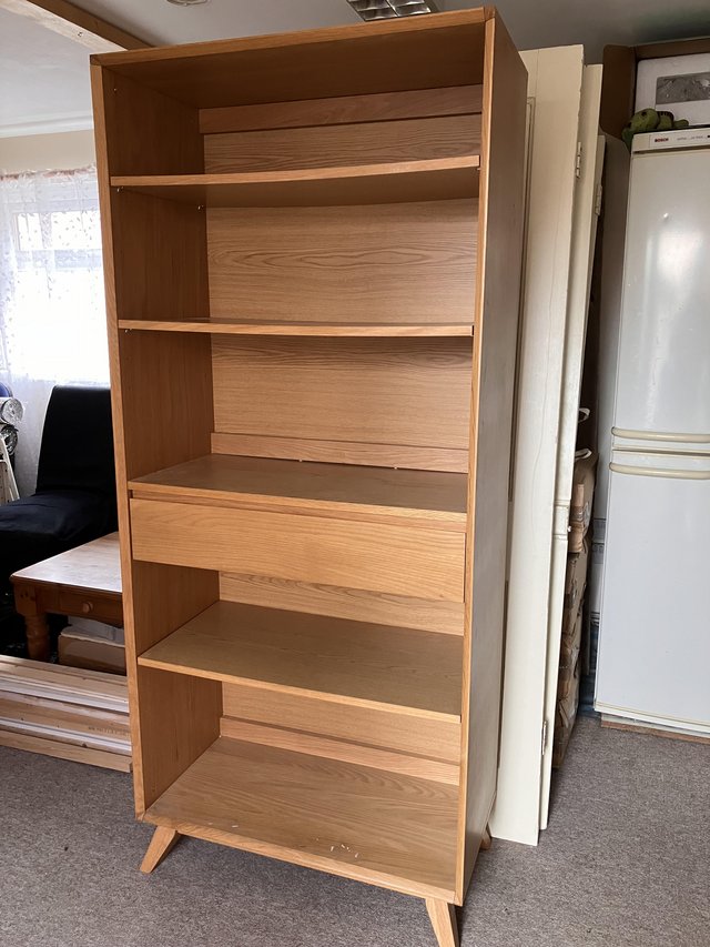 Preview of the first image of Upright wooden bookcase with shelves and a hidden drawer.