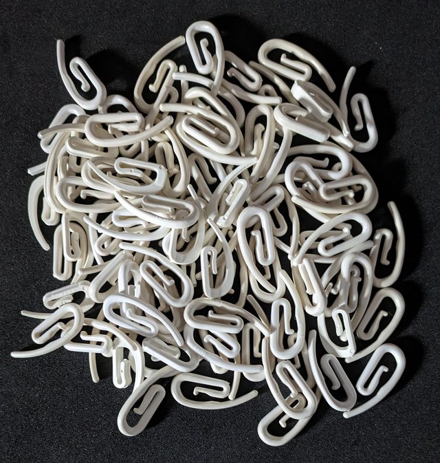 Preview of the first image of Over 80 plastic curtain hooks.
