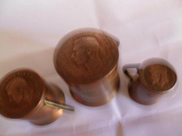 Image 1 of Three minature copper mugs with coins for their bases