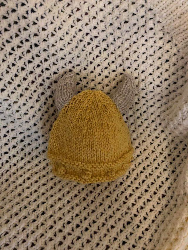 Preview of the first image of Hand knit and crocheted baby hats.
