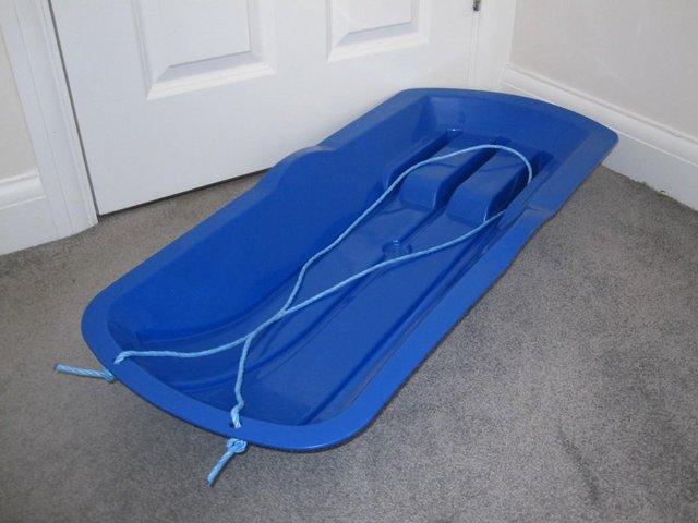 Preview of the first image of Blue plastic Sledge great for snow and sand.