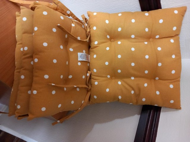 Preview of the first image of Sainsburys mustard polka dot seat cushions x 4.