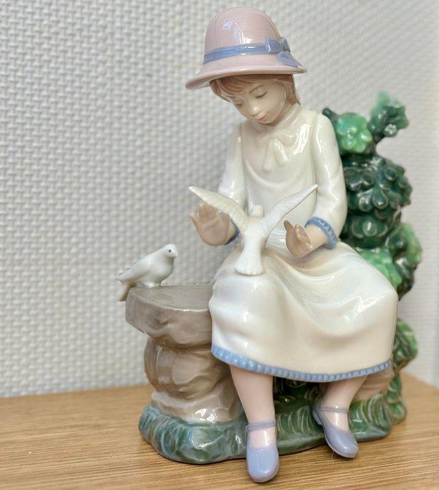 Preview of the first image of Lladro Nao “Girl feeding birds”. Perfect condition..