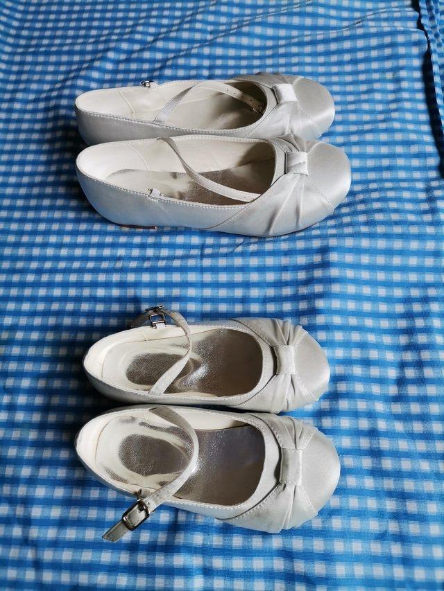 Preview of the first image of Children's silver satin shoes with buckle strap.