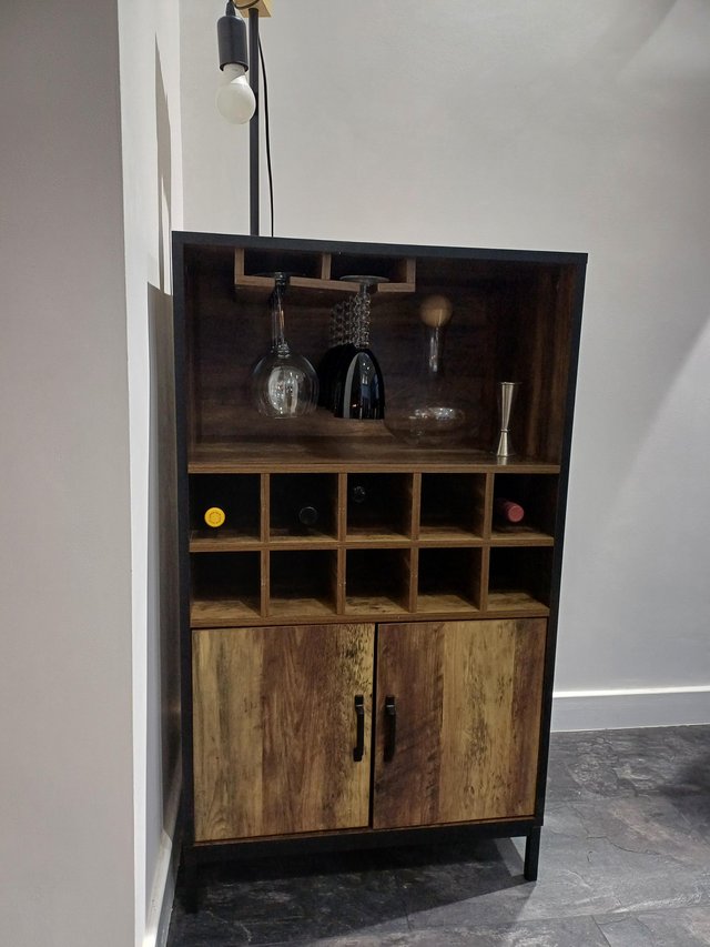 Preview of the first image of Drinks cabinet with storage and glass holder.
