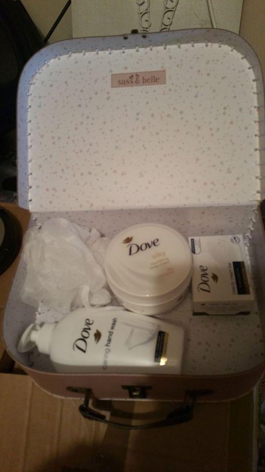 Preview of the first image of Brand New Dove body products in small pink suit case.
