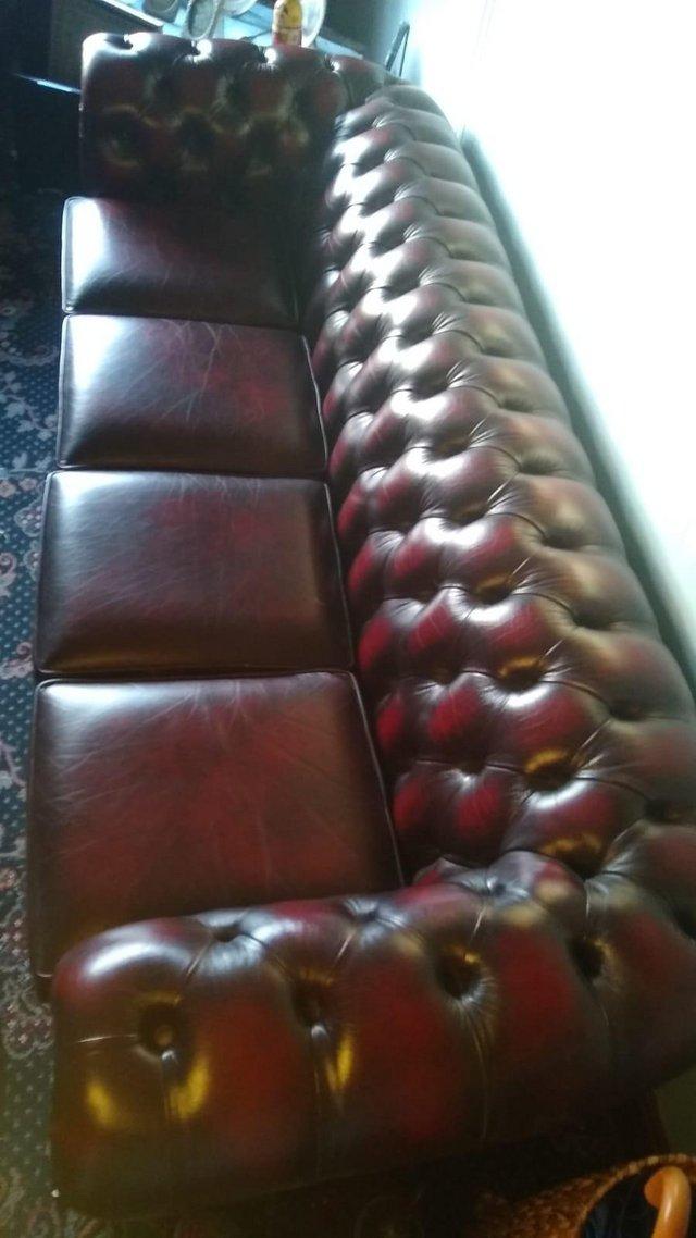Preview of the first image of 4 seater ox blood leather chesterfield sofa.
