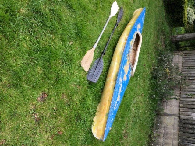 Preview of the first image of Fibreglass canoe with paddle.