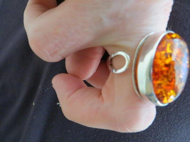 Preview of the first image of Cognac Amber Adjustable Ring in silver setting.