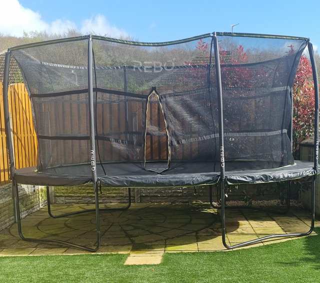 Preview of the first image of Rebo Trampoline 12 x 16 ft with ladder and enclosure.