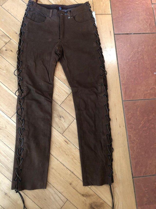 Preview of the first image of Brand new, 32W, Long, suede Hein Gericke string side jeans.