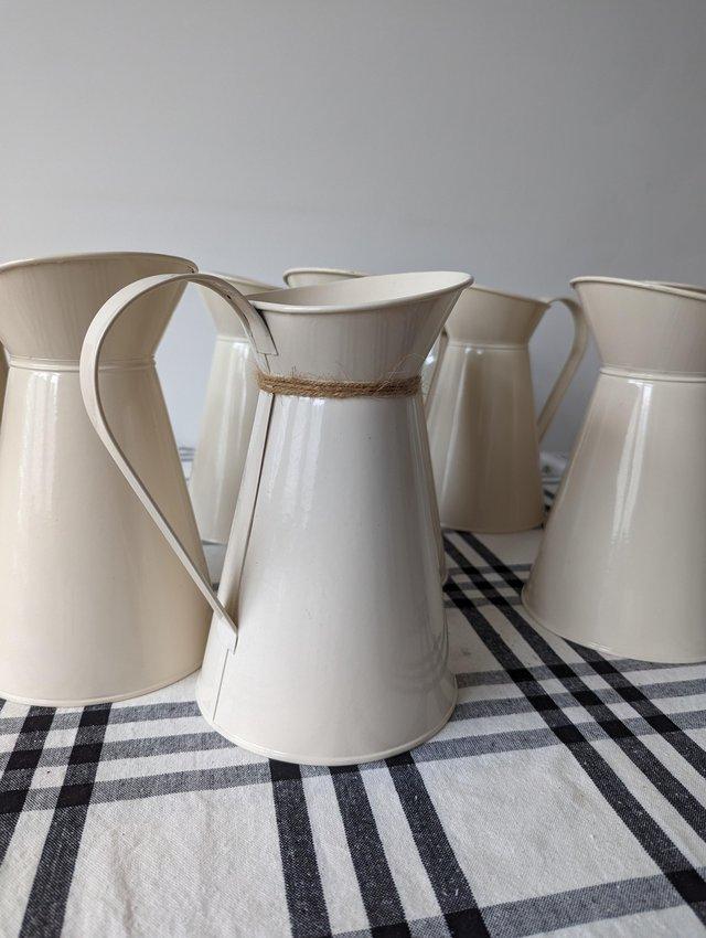 Preview of the first image of 10 x cream metal milk jug vases - wedding/event centrepiece.