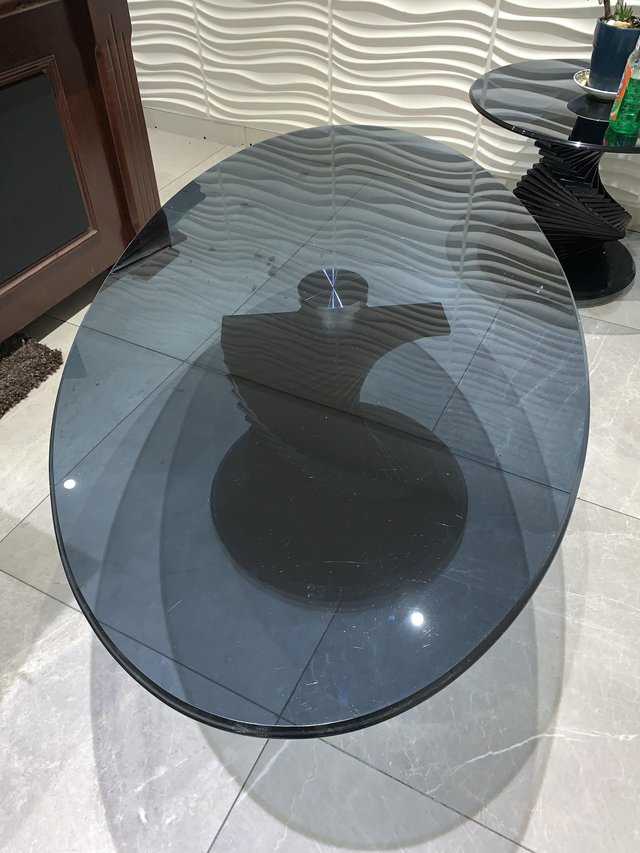 Preview of the first image of Round dark glass long oval coffe table, second hand.