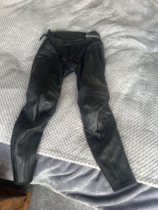Preview of the first image of Black leather Rev’it motorcycle trousers.