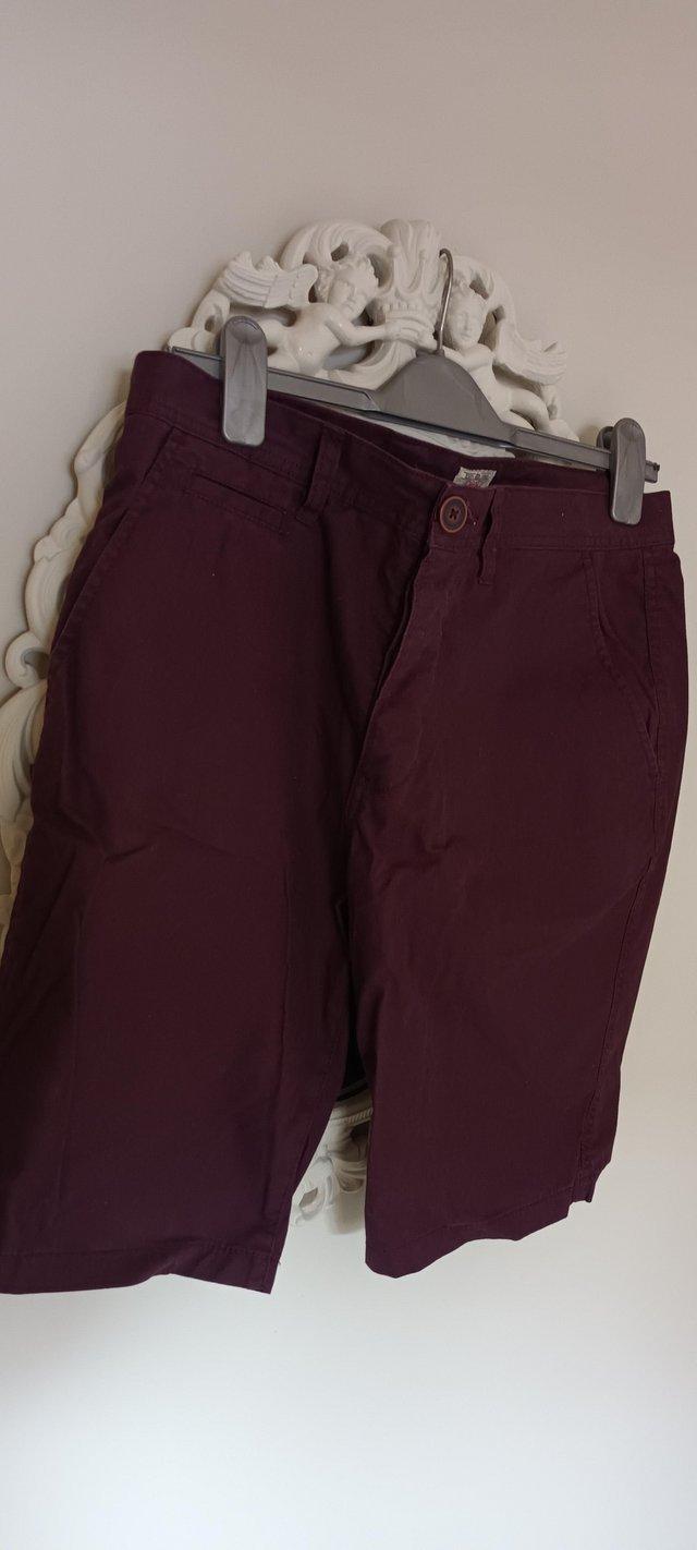 Preview of the first image of NEXT Chino shorts, size 30, dark red/burgundy colour.
