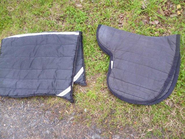 Preview of the first image of 2 Black Full size saddle pads RAMBO AND POLYPADS.