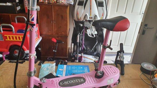Preview of the first image of 24 volt electric ride on e- scooter in pink.