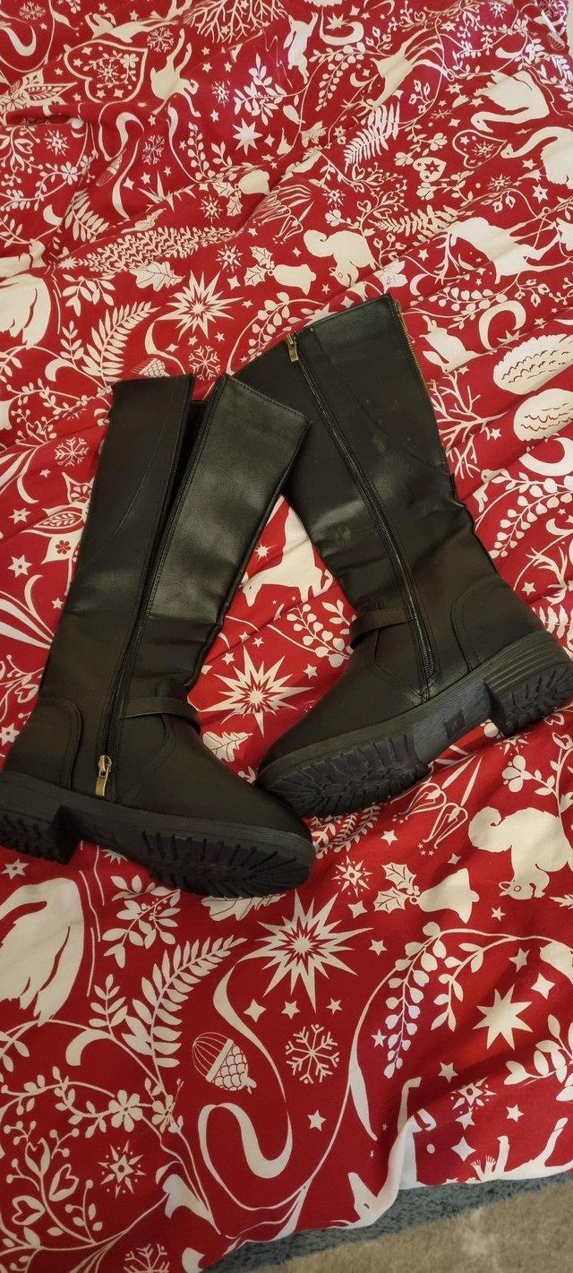 Preview of the first image of Brand New Black women's long boots.