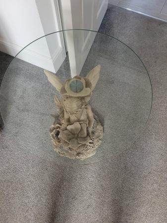 Image 1 of GLASS TOP SIDE TABLE WITH AN ANGEL AS THE TABLE