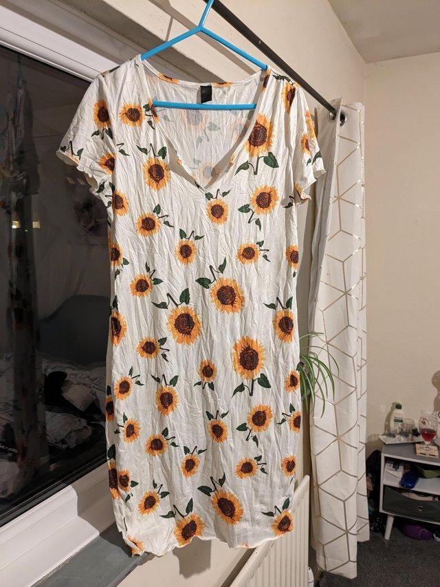Preview of the first image of Woman's mini dress with sunflowers.