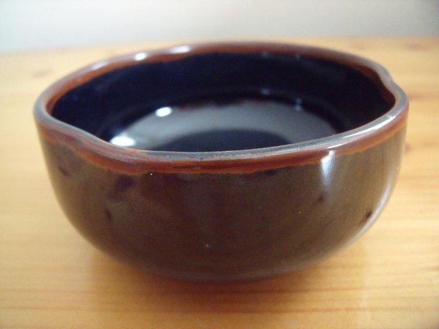 Preview of the first image of Attractive highly glazed dark blue/brown dish- ‘pinched’ rim.