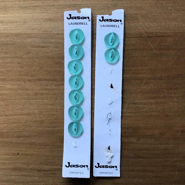 Preview of the first image of Unused vintage 9 light green Jason Laundwell buttons on card.