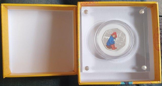 Preview of the first image of R.Mint Paddington At the Station Silver Proof Coloured 50p.