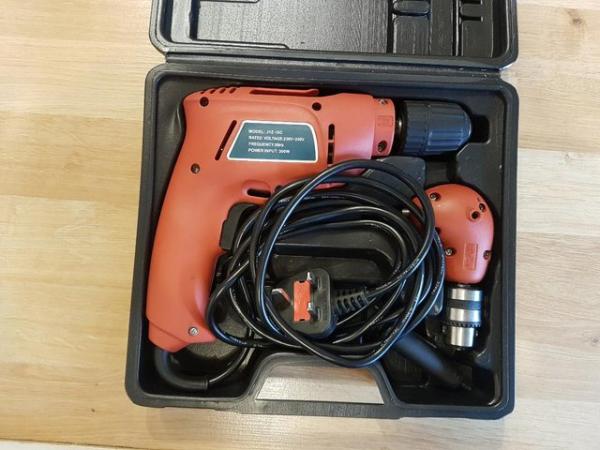 Image 1 of Electric drill with attachment for drilling angles, boxed.