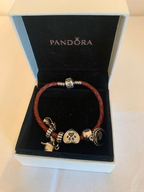 Preview of the first image of Genuine Pandora Leather Bracelet with Four Charms.